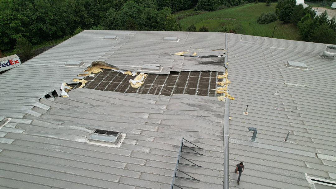Aerial drone photo documenting storm damage to a commercial warehouse roof in Northeast Ohio — shot by FAA Part 107 licensed pilot Ed Rich of NE Ohio Drone